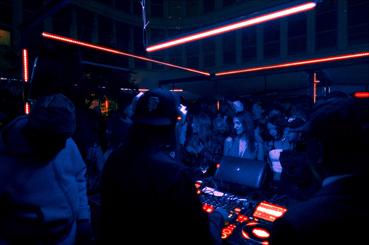 Blue-lit crowd behind the DJ